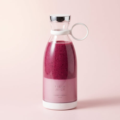 Swirlette portable blender in White, filled with a berry smoothie, with a chrome lid and carry ring. [White]