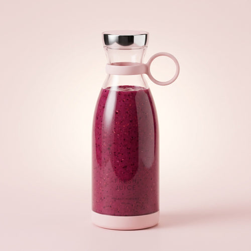 Swirlette portable blender in Blush, filled with a berry smoothie, with a chrome lid and carry ring. [Blush]