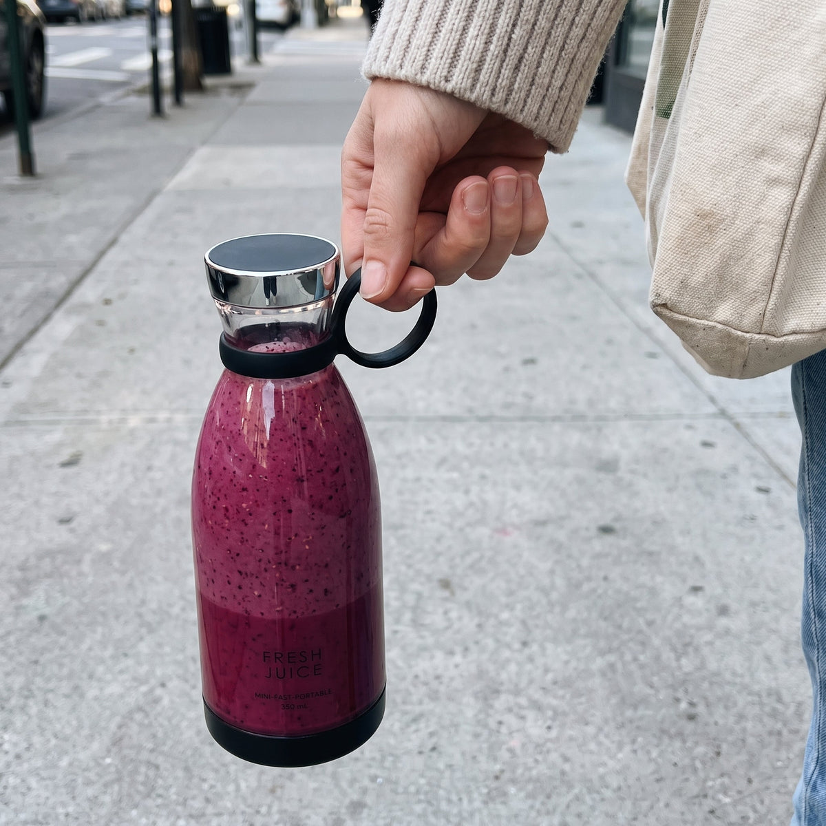 Carrying a Black Swirlette smoothie down a city sidewalk.