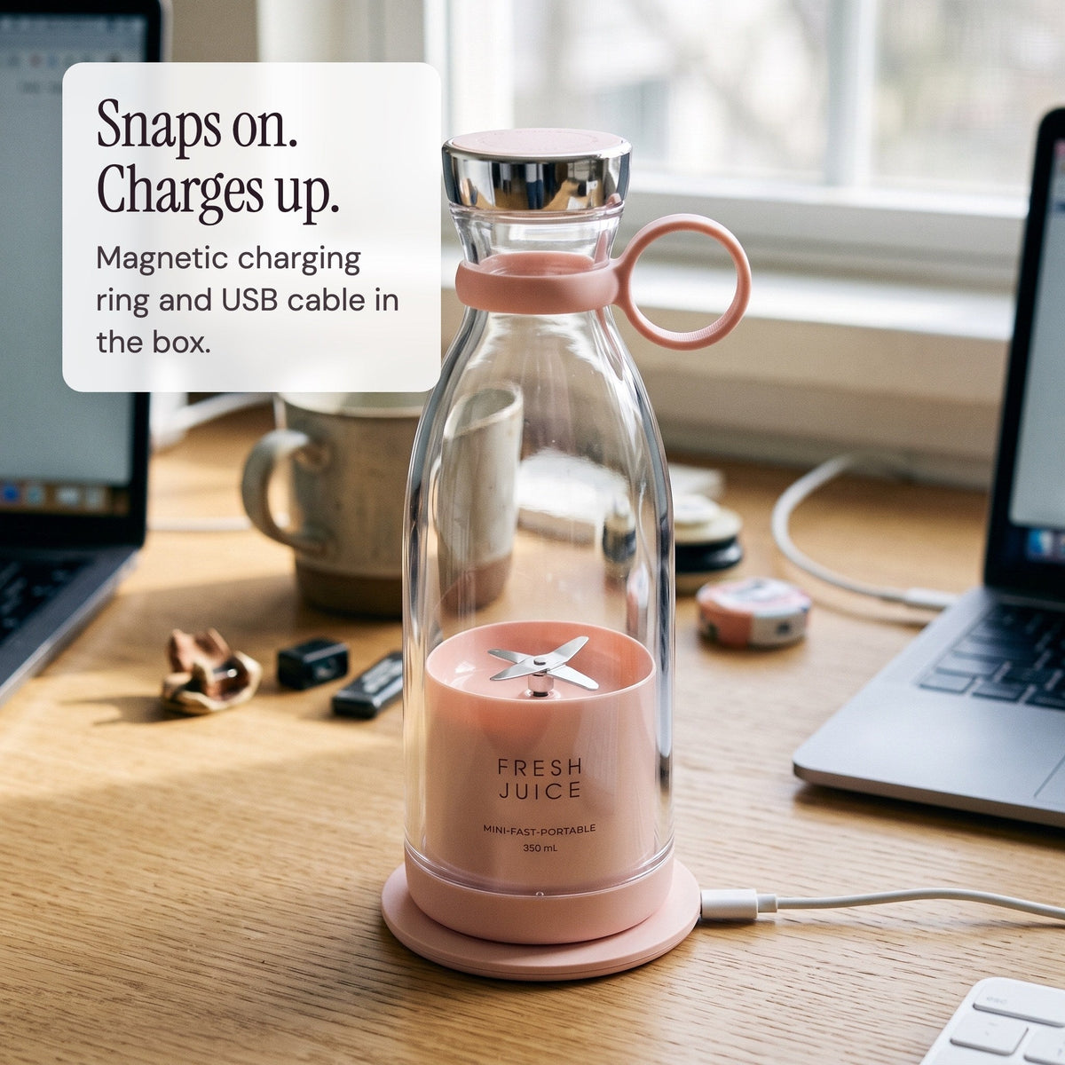 Blush Swirlette charging on its magnetic charging ring on a desk.