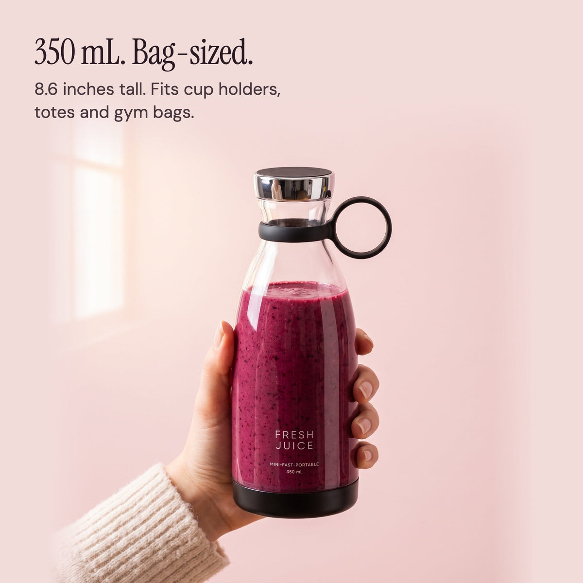 A hand holding the 350 mL Black Swirlette to show its size.