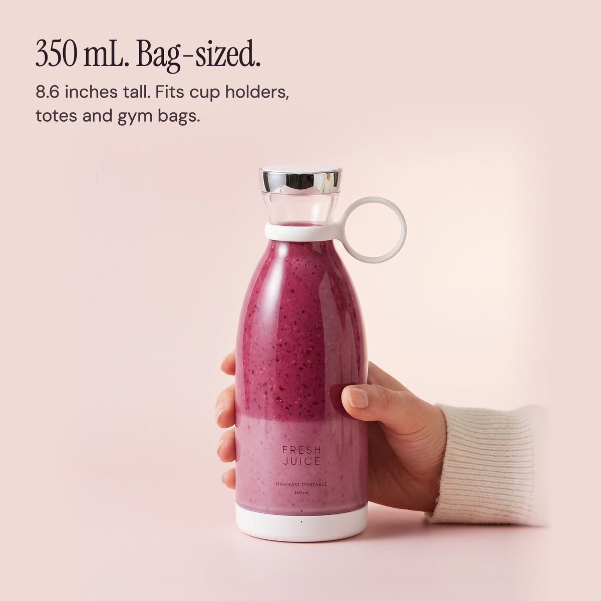 A hand holding the 350 mL White Swirlette to show its size.